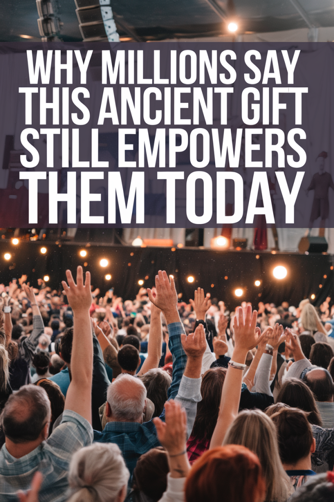 A large, diverse crowd with raised hands, glowing orbs of light floating among them, symbolizing unity and inspiration